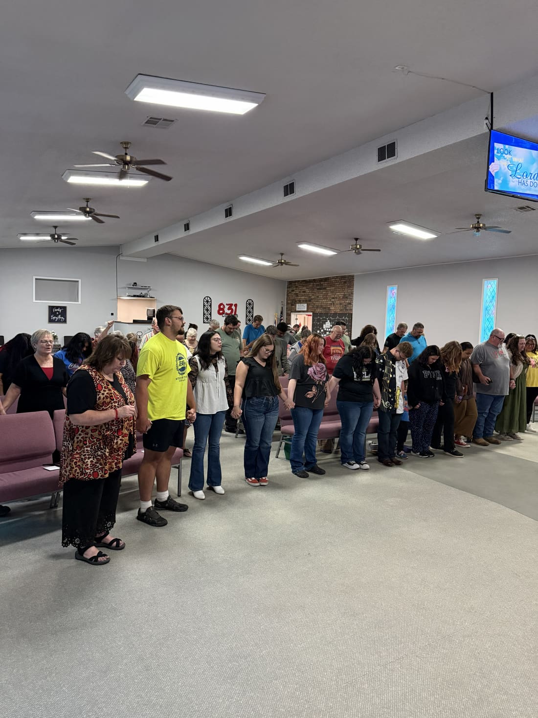 Church family praying together between the pews
